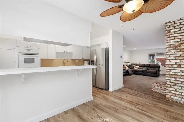 a kitchen with stainless steel appliances a refrigerator and microwave