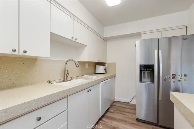 a kitchen with a sink and refrigerator
