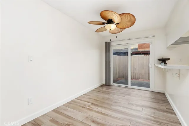 a view of a room with wooden floor and cabinet
