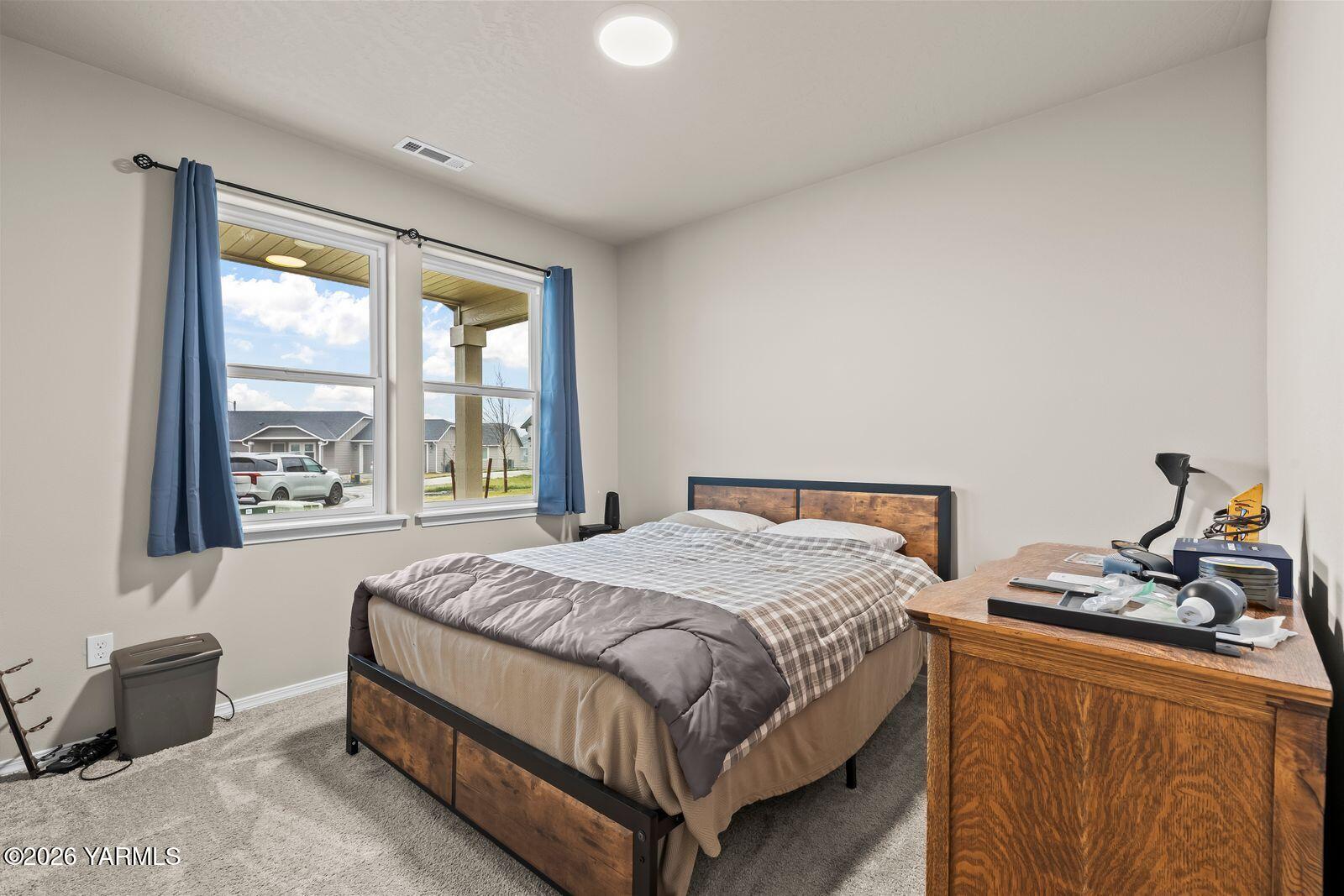 403 Lambert Court Grandview, WA 98930 - Photo 11 of 27 a bedroom with a bed and wooden floor