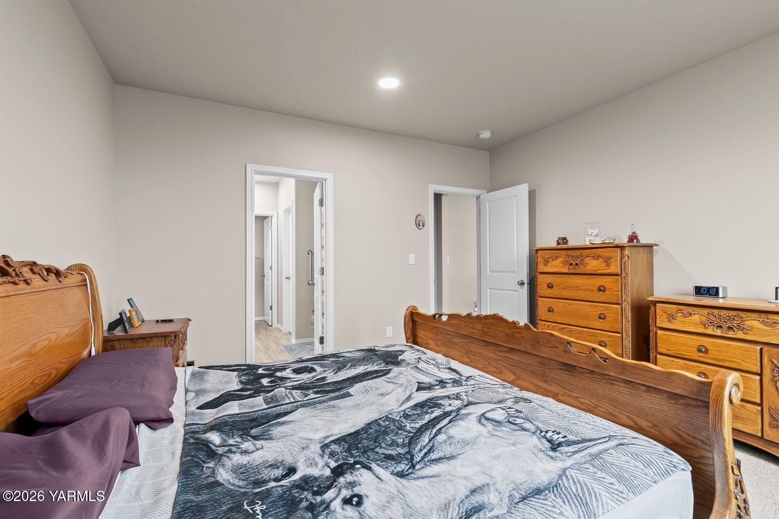 403 Lambert Court Grandview, WA 98930 - Photo 17 of 27 a bedroom with a bed and wooden floor