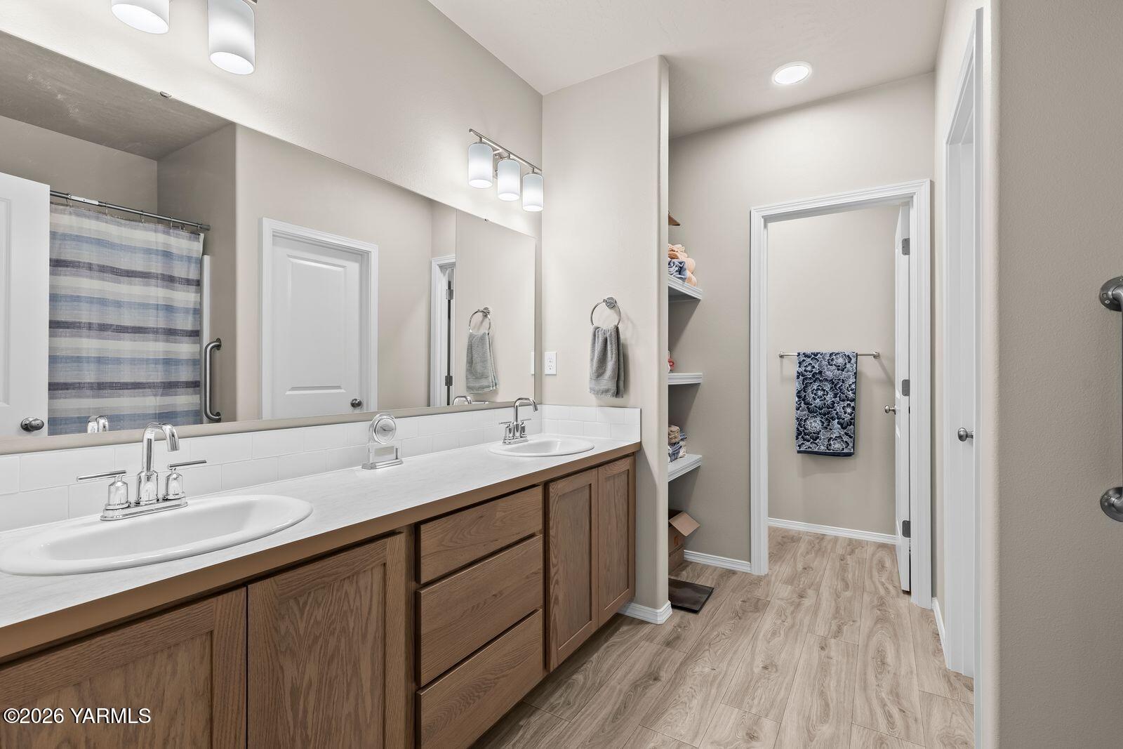 403 Lambert Court Grandview, WA 98930 - Photo 18 of 27 a bathroom with a double vanity sink and a mirror