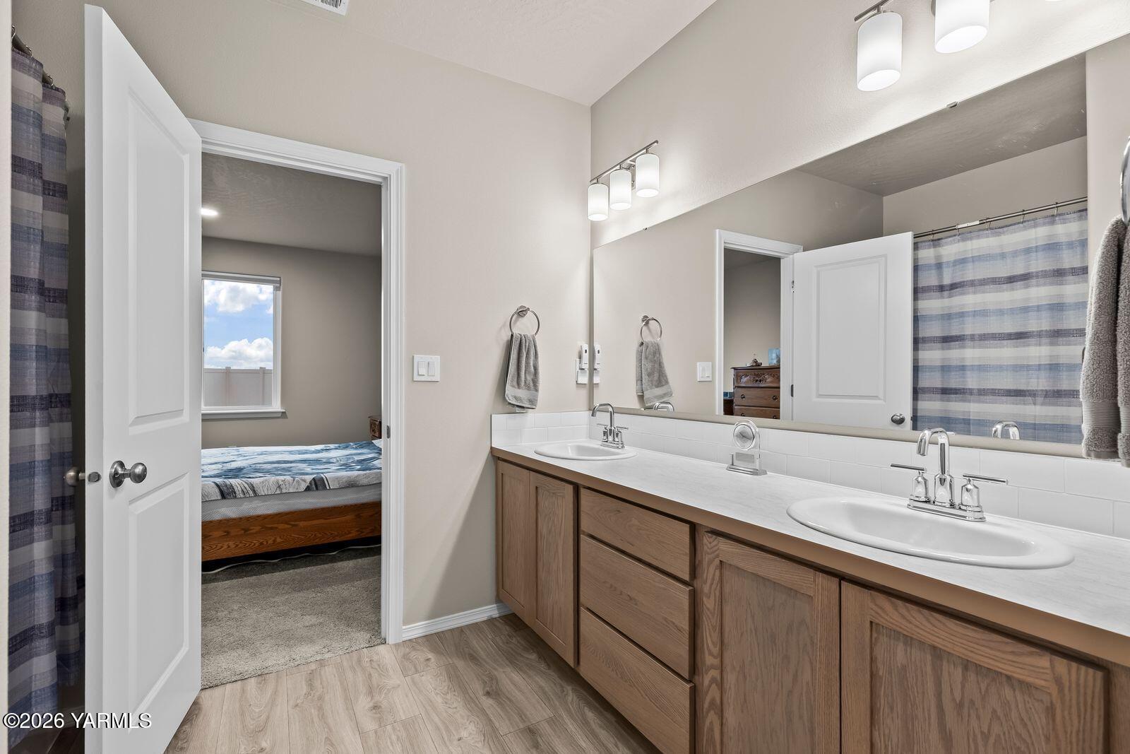 403 Lambert Court Grandview, WA 98930 - Photo 19 of 27 a en suite bathroom with a double vanity sink and mirror