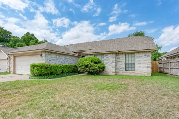 a view of a house with a yard and garage