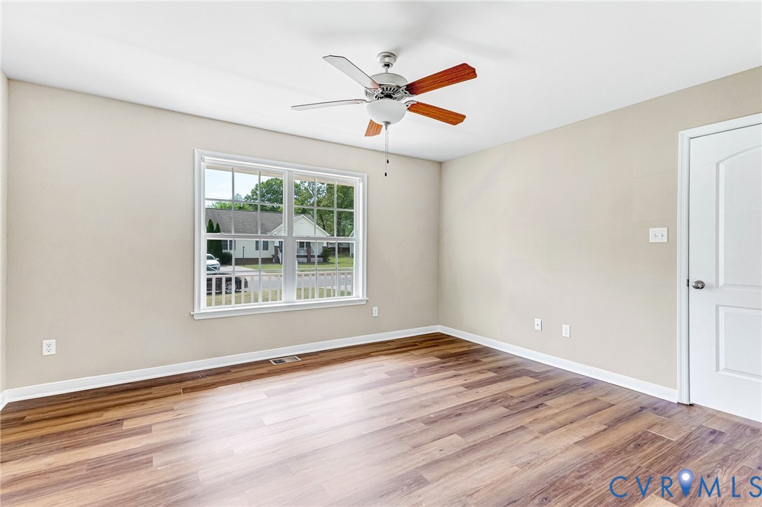 9925 Reymet Court Richmond, VA 23237 - Photo 16 of 30 a view of an empty room with wooden floor and a window
