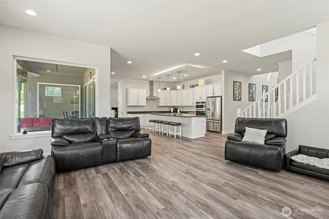 a living room with furniture and kitchen view