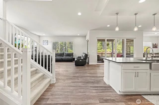 a kitchen with stainless steel appliances granite countertop a sink and a large window