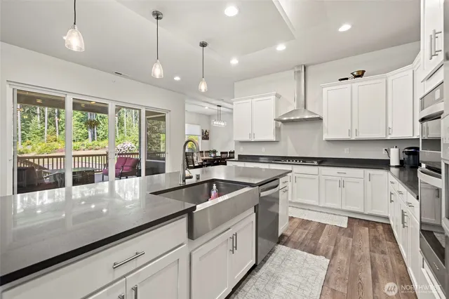 a kitchen with white cabinets and a stove with white countertops