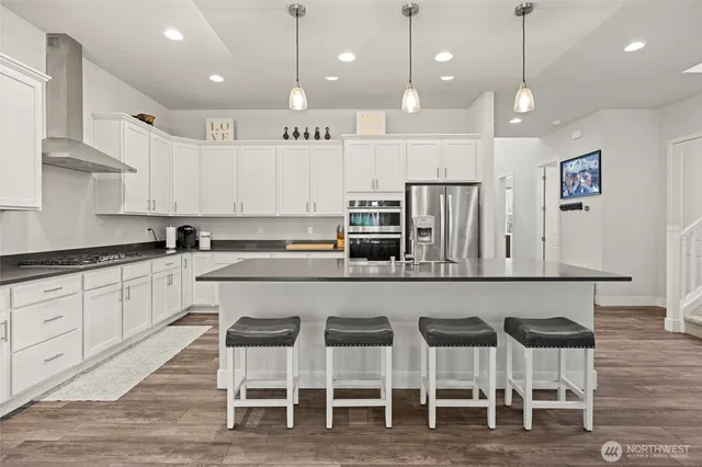 a view of a room with wooden floor and windows