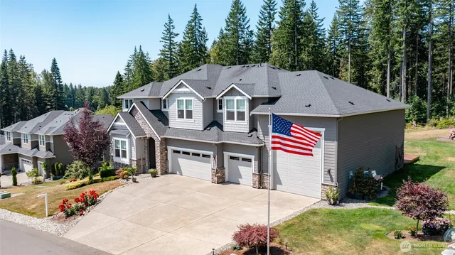 a aerial view of a house with a yard and potted plants