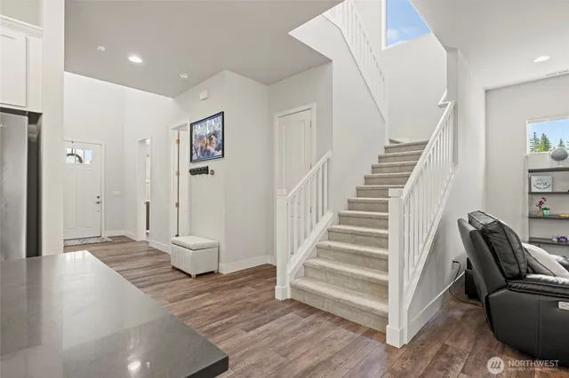 a bedroom with a bed and windows