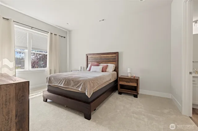 a bathroom with a shower sink vanity mirror and toilet
