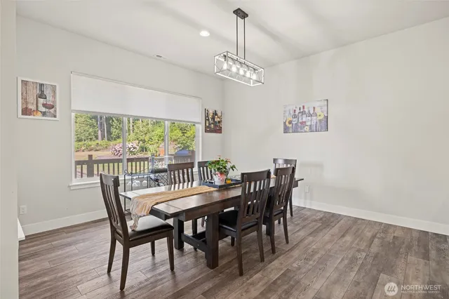 a view of a workspace with furniture and wooden floor