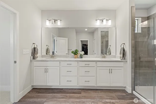 a view of walk in closet with clothes