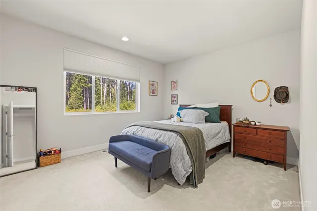 a living room with furniture a rug and a wall painting
