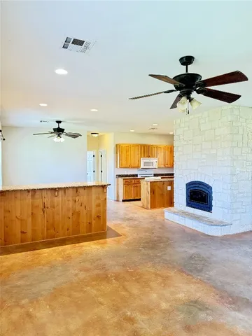a view of a livingroom with a ceiling fan and window