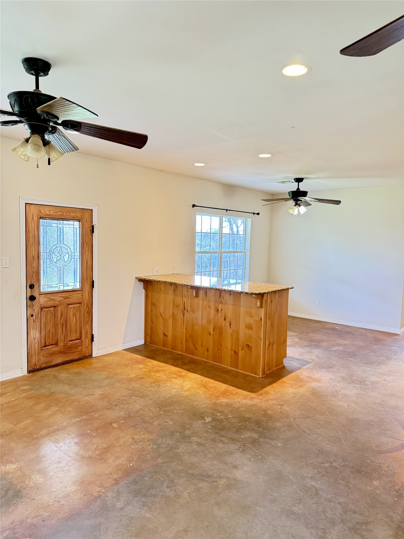 11791 Silver Springs Road Rockdale, TX 76567 - Photo 14 of 28 a view of a livingroom with a ceiling fan and window