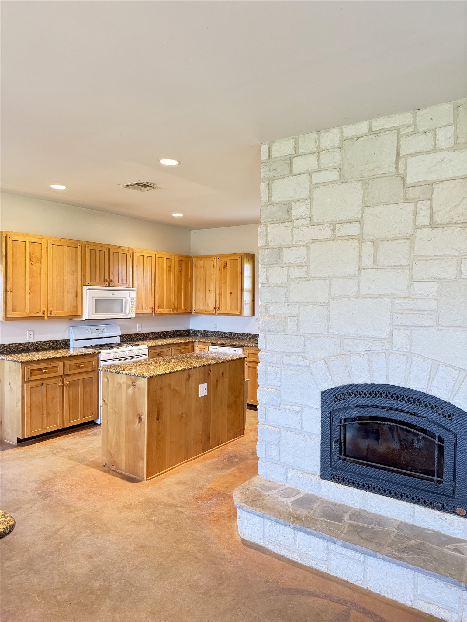 11791 Silver Springs Road Rockdale, TX 76567 - Photo 15 of 28 a kitchen with stainless steel appliances granite countertop a stove a sink and a microwave
