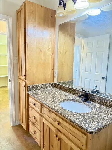 a kitchen with stainless steel appliances granite countertop a sink and a white cabinets