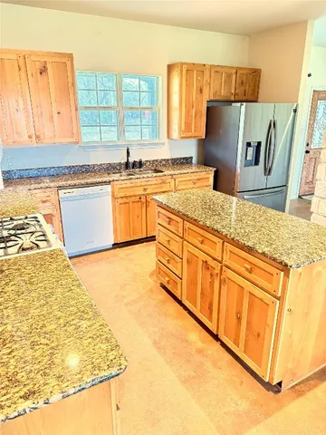 a kitchen with granite countertop a sink and a window