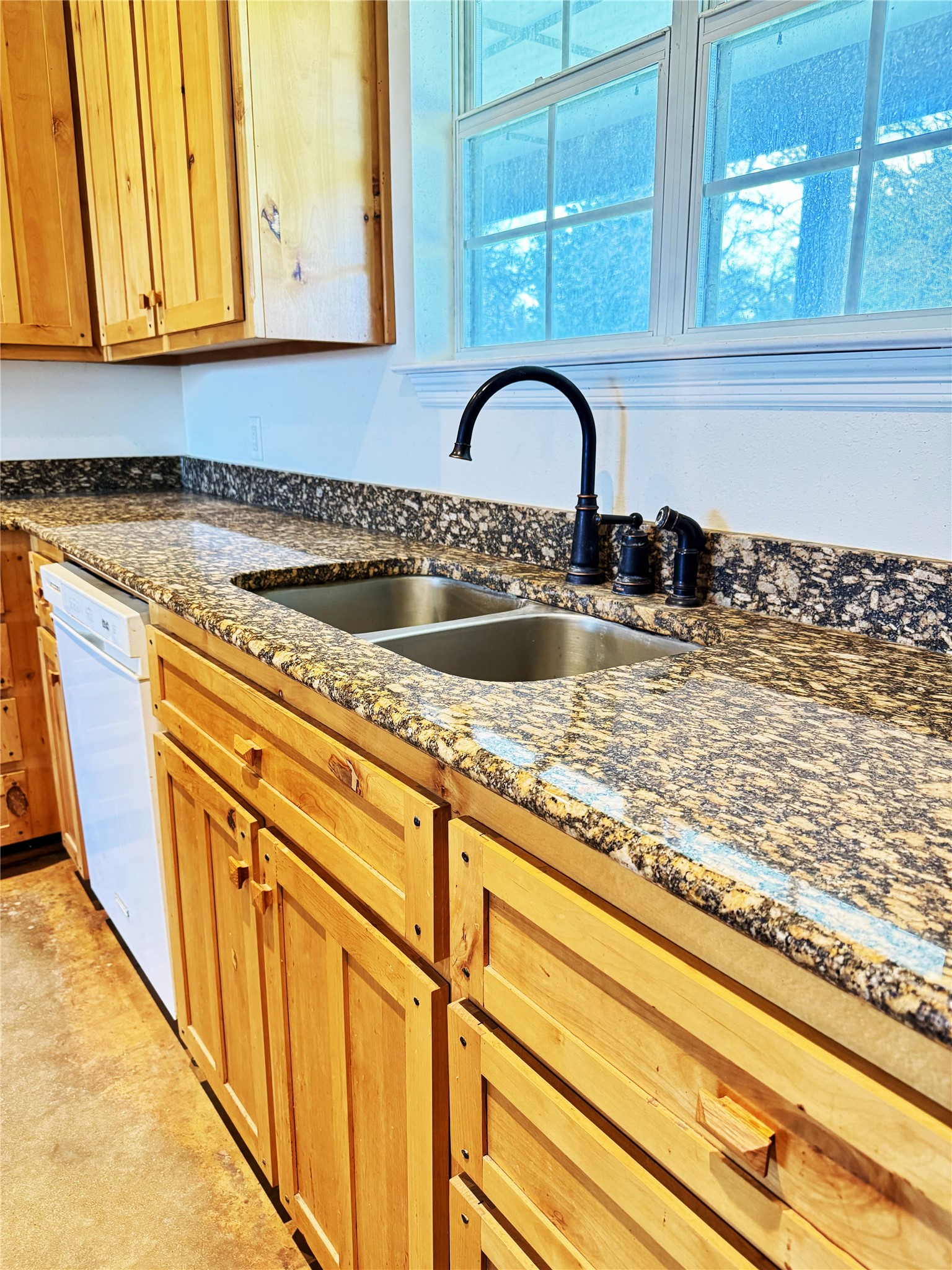 11791 Silver Springs Road Rockdale, TX 76567 - Photo 23 of 28 a kitchen with granite countertop a sink and cabinets
