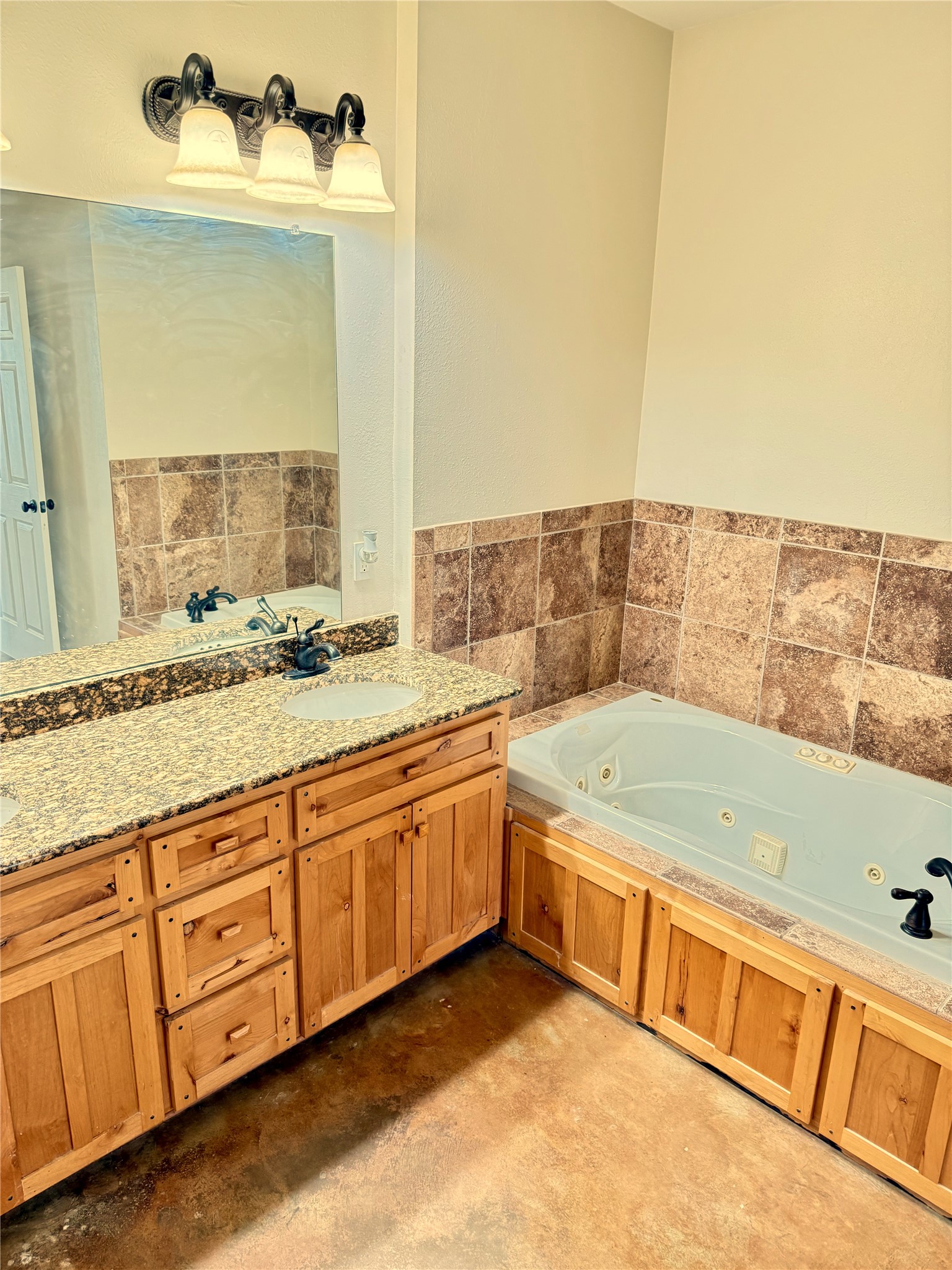 11791 Silver Springs Road Rockdale, TX 76567 - Photo 25 of 28 a bathroom with a tub sink and mirror