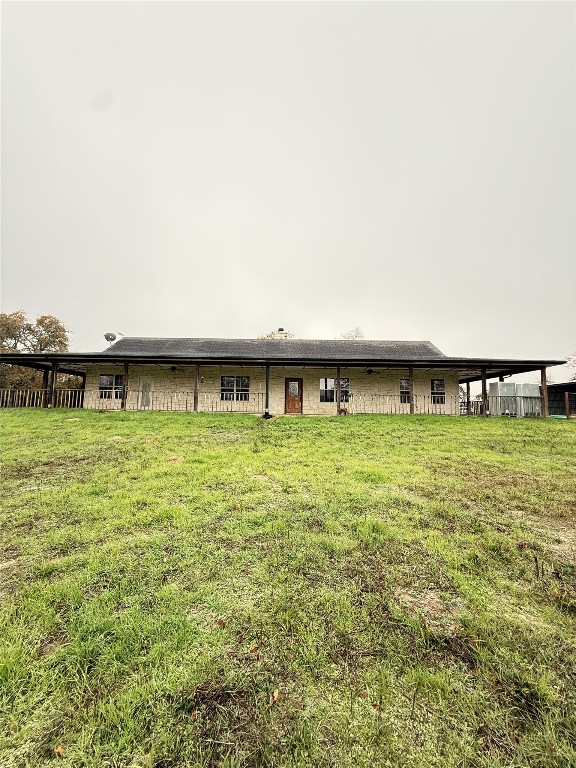 11791 Silver Springs Road Rockdale, TX 76567 - Photo 27 of 28 Back of house with a lawn