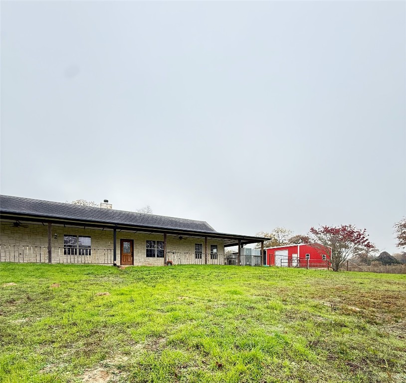 11791 Silver Springs Road Rockdale, TX 76567 - Photo 5 of 28 Back of property featuring a yard and a chimney