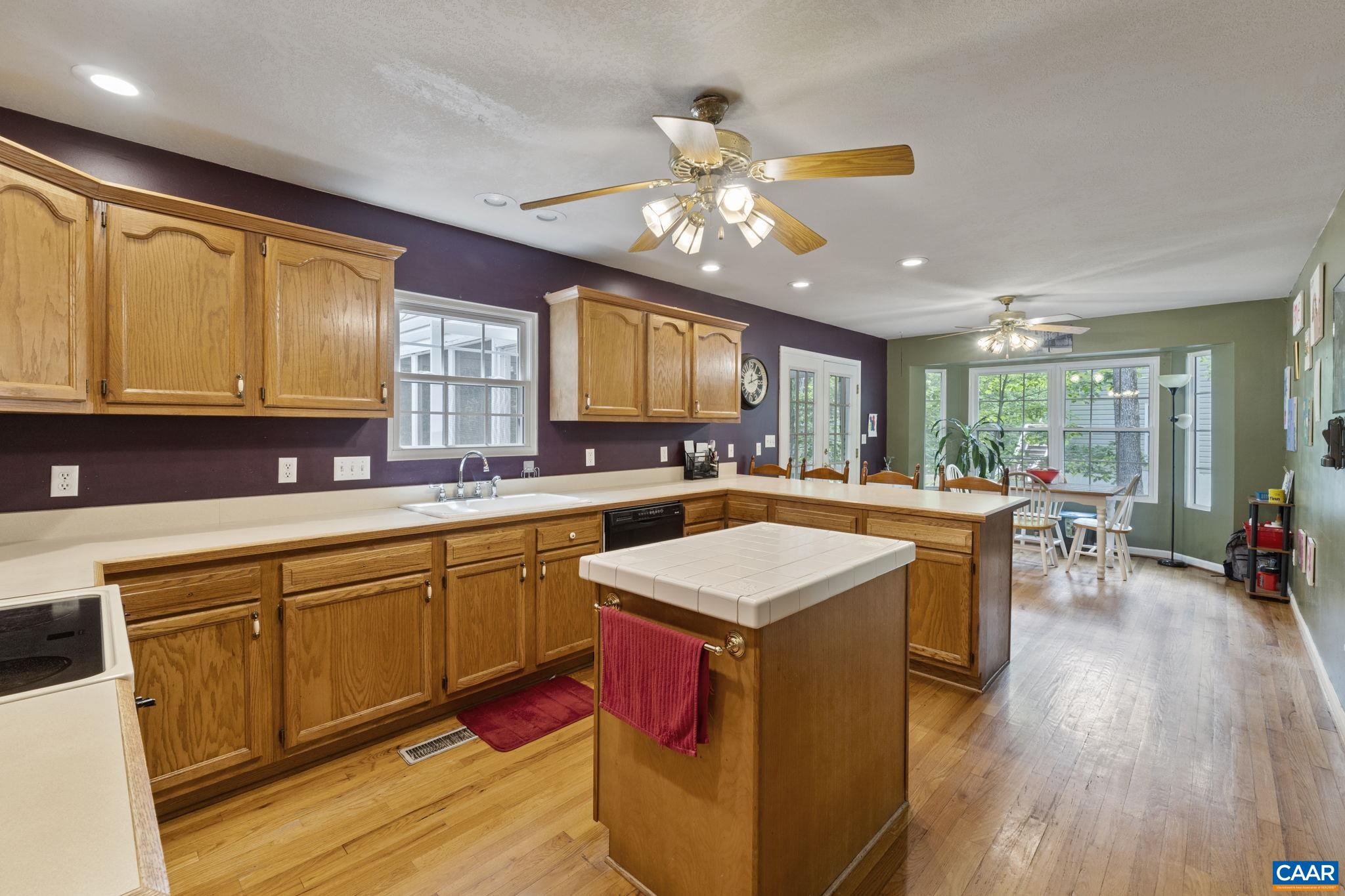 42 Oak Grove Road Palmyra, VA 22963 - Photo 13 of 37 a kitchen with a stove a sink a dining table and chairs
