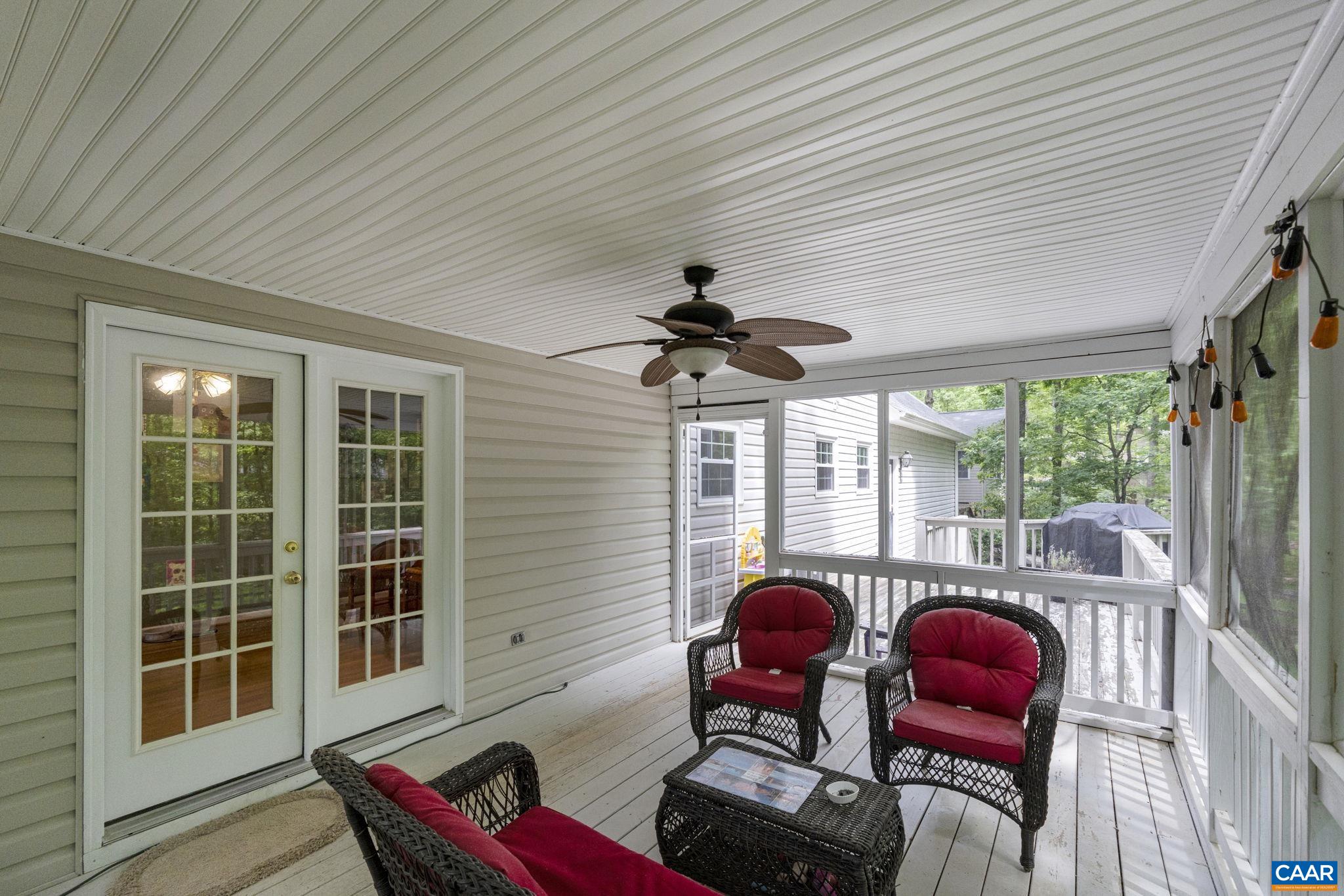 42 Oak Grove Road Palmyra, VA 22963 - Photo 20 of 37 a living room with furniture a rug potted plant and a large window