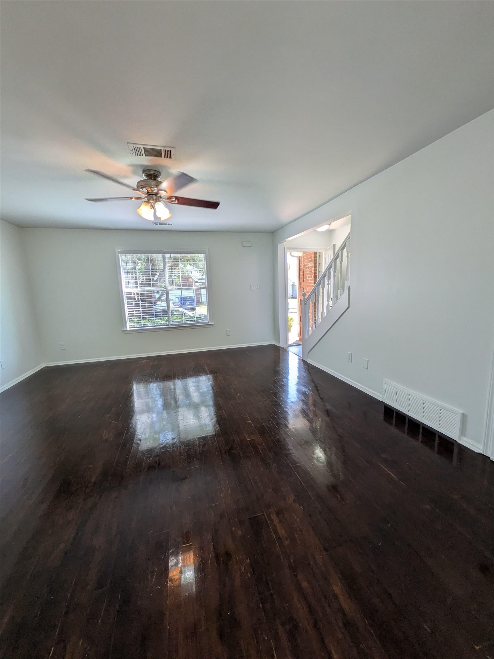 10006 Cameron Ridge Trail Memphis, TN 38016 - Photo 6 of 29 a view of an empty room with wooden floor and a window