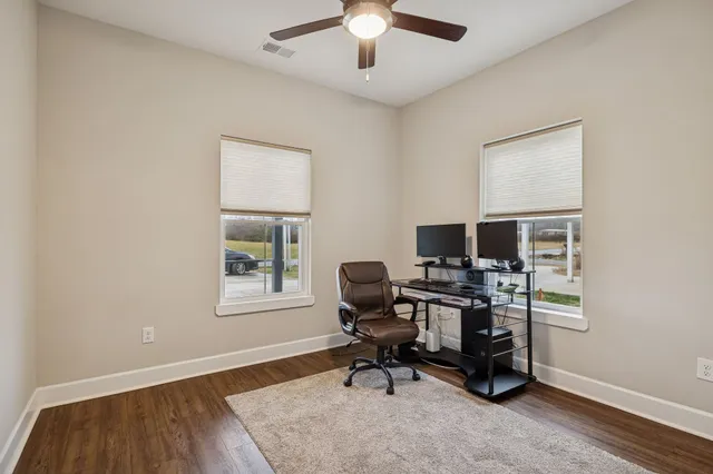 a workspace with wooden floor and a window