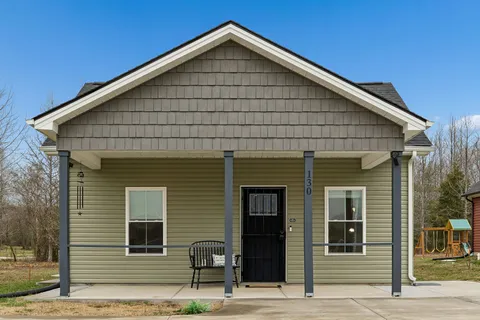 a view of a house with wooden deck