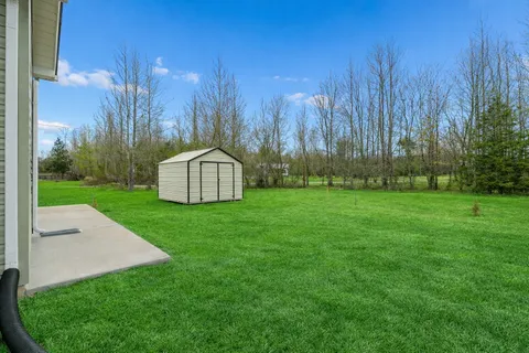 a backyard of a house with lots of green space