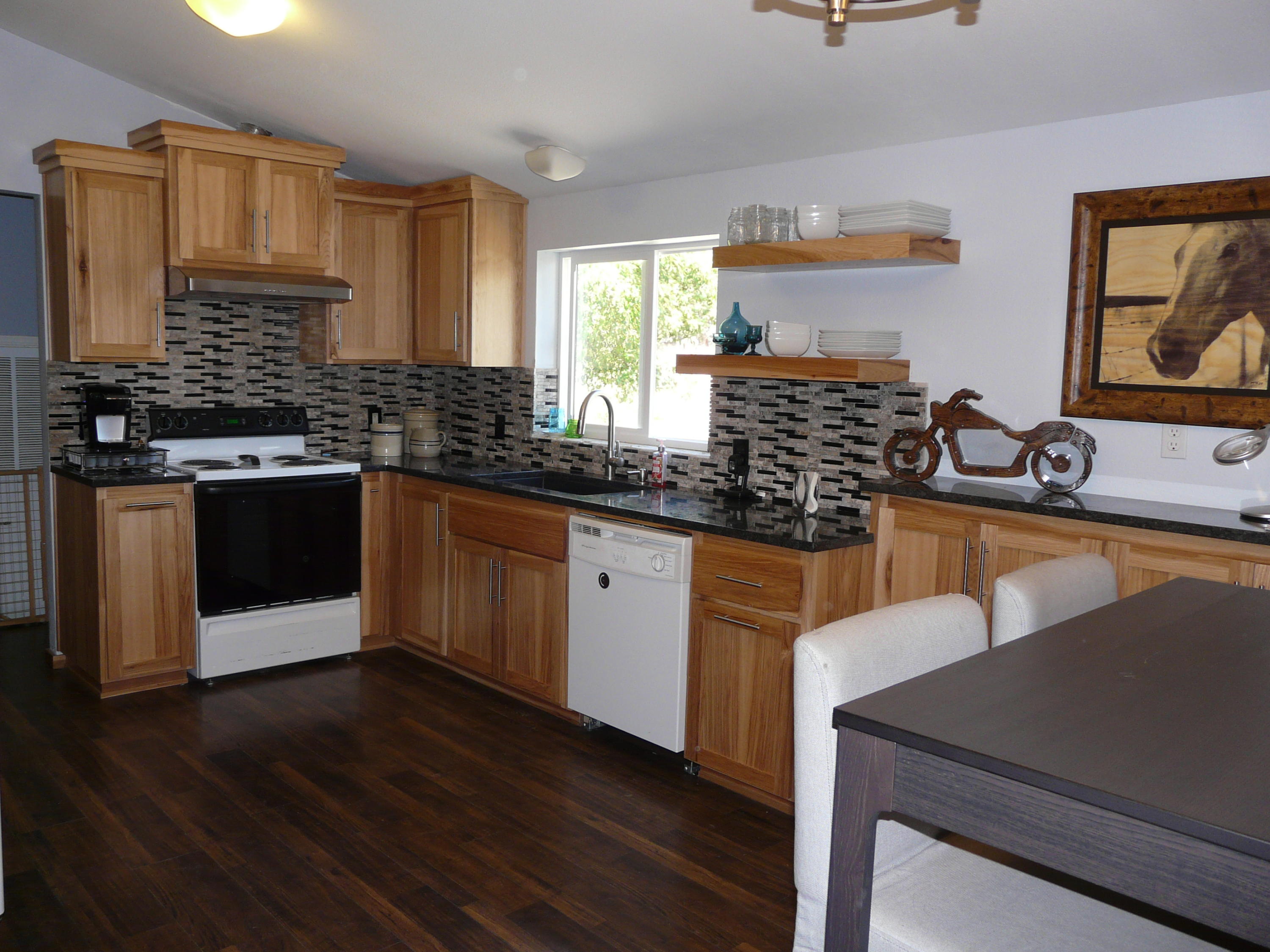 60872 Raintree Court Bend, OR 97702 - Photo 7 of 18 Beautifully custom cabinets made for this home. Glass backsplash.