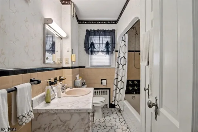 a bathroom with a tub sink and mirror