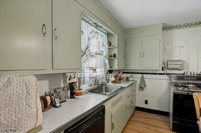 a kitchen with a sink stove and cabinets