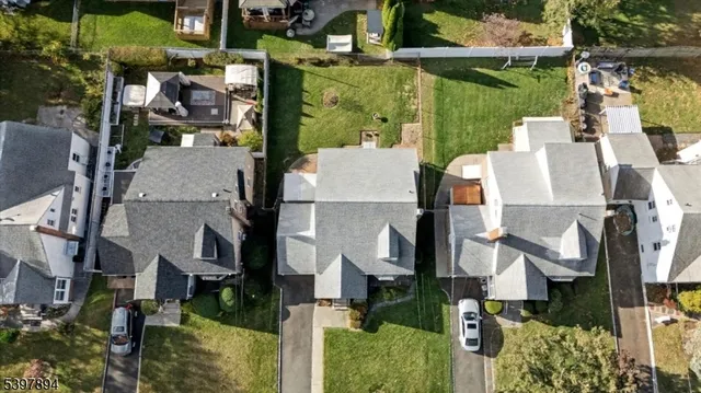 an aerial view of houses with outdoor space and parking
