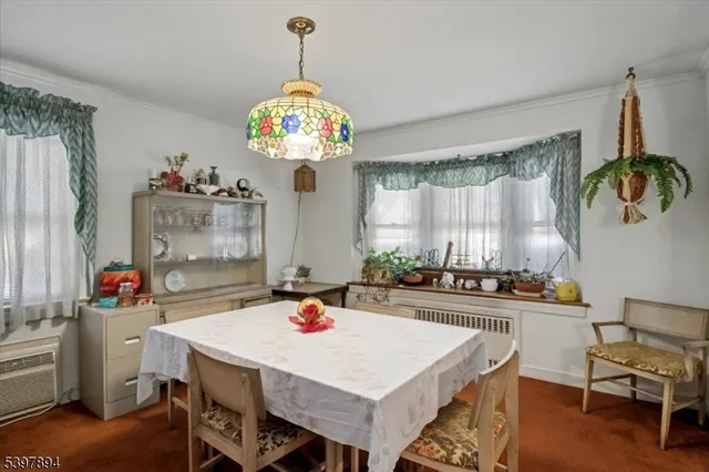 a kitchen with a table and a chandelier