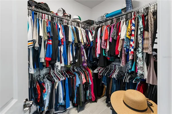 a view of walk in closet with clothes