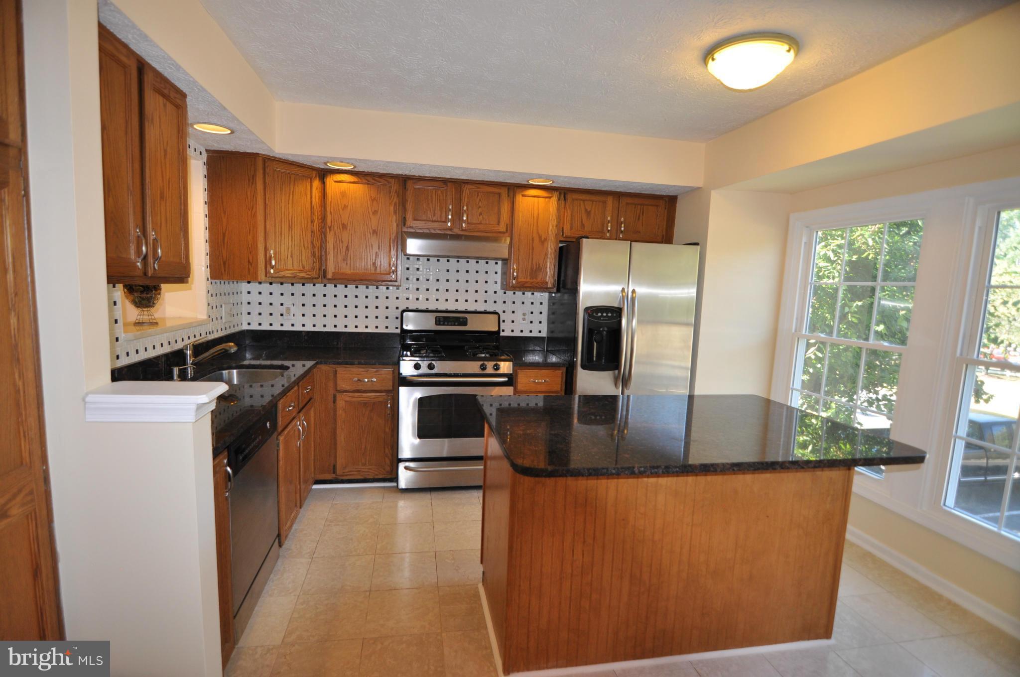 2433 Warm Spring Way Odenton, MD 21113 - Photo 8 of 28 Granite Island Kitchen with Ceramic Floor