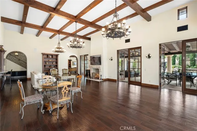 a view of a dining room with furniture wooden floor and chandelier