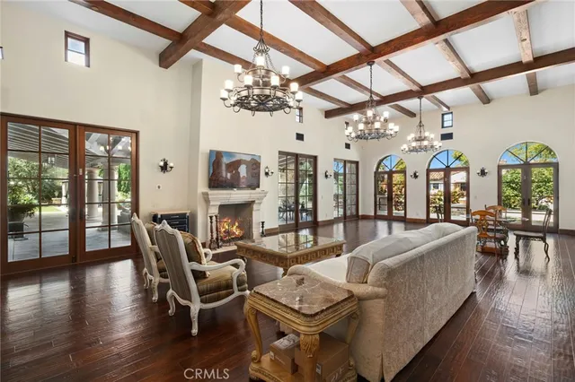 a view of a dining room with furniture a chandelier and wooden floor