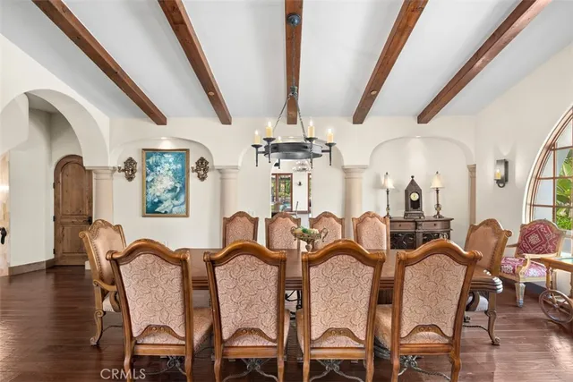 a view of a dining room with furniture and chandelier