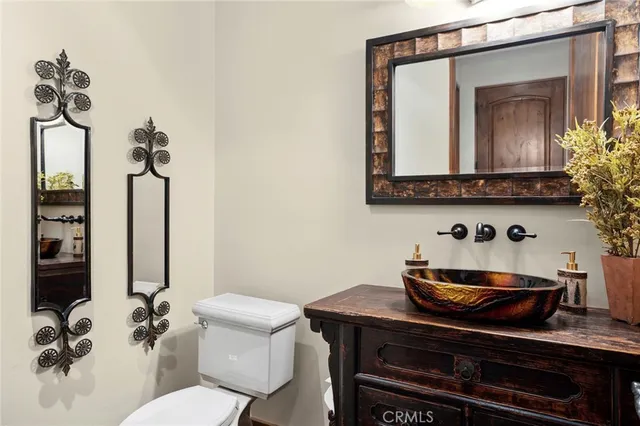 a bathroom with a toilet a sink and mirror