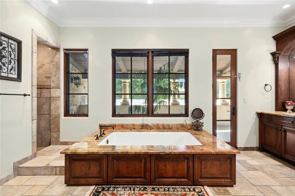 a bath tub sitting in a bathroom next to a window