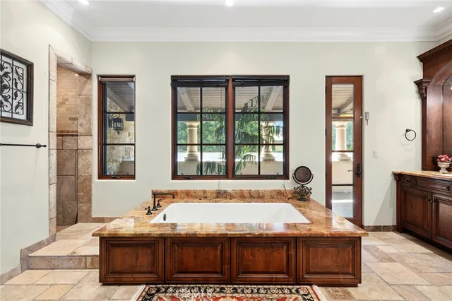 a bath tub sitting in a bathroom next to a window
