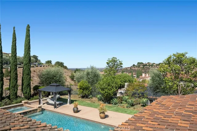 a view of a patio with a table and chairs with wooden floor and fence