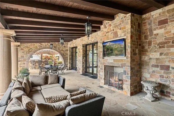 a living room with furniture a fireplace and a floor to ceiling window