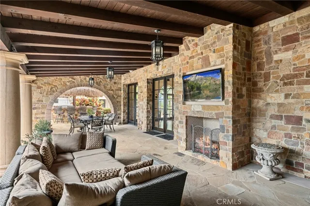a living room with furniture a fireplace and a floor to ceiling window